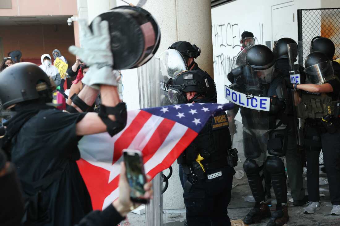 Protesters throw trash and objects as they clash with federal agents and police during a "National Shutdown" protest against Immigration and Customs Enforcement in Los Angeles on January 30.