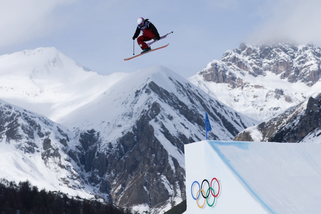 A skier goes off a jump.