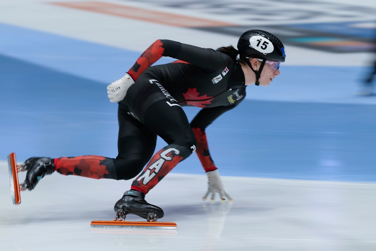 A woman competes in speed skating.
