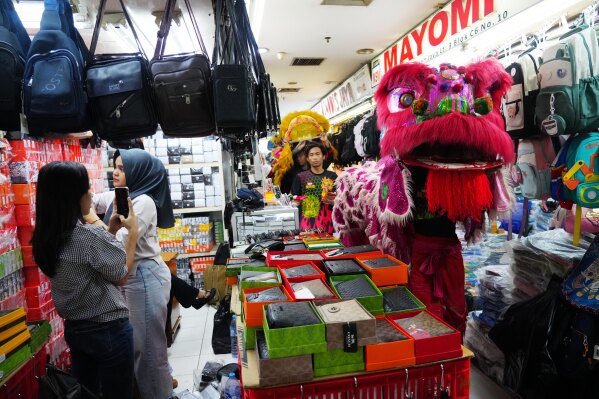 Lion dancers perform at a market in preparation for the Lunar New Year celebration in Jakarta, Indonesia, Thursday, Feb. 12, 2026.( AP Photo/Tatan Syuflana)