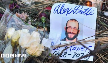 Flowers are left at a makeshift memorial in the area where Alex Pretti was shot dead a day earlier by federal immigration agents in Minneapolis, Minnesota, on January 25, 2026.