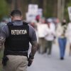 A Krome Detention Center officer patrols as people hold a vigil to recognize those who have died in U.S. Immigration and Customs Enforcement custody as well as those affected by mass deportations on May 24 outside Krome Detention Center in Miami.