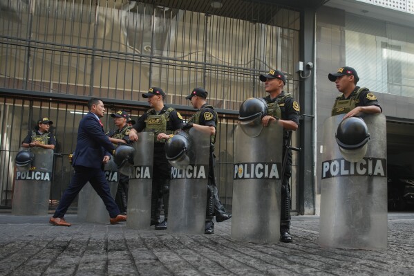 Police stand guard outside the location where lawmakers are debating the removal of Peruvian President Jose Jeri in Lima, Peru, Tuesday, Feb. 17, 2026. (AP Photo/Guadalupe Pardo)