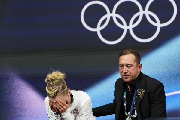 Amber Glenn of the United States reacts to her score after competing in the women's short program in figure skating at the 2026 Winter Olympics, in Milan, Italy, Tuesday, Feb. 17, 2026. (AP Photo/Natacha Pisarenko)