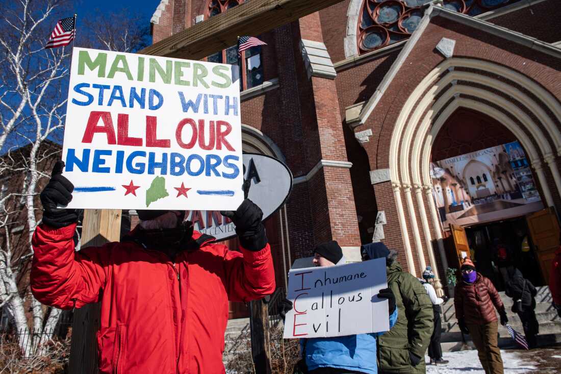 Demonstrators holding signs and wearing winter clothing attend an anti-ICE rally in Lewiston, Maine, on January 24.