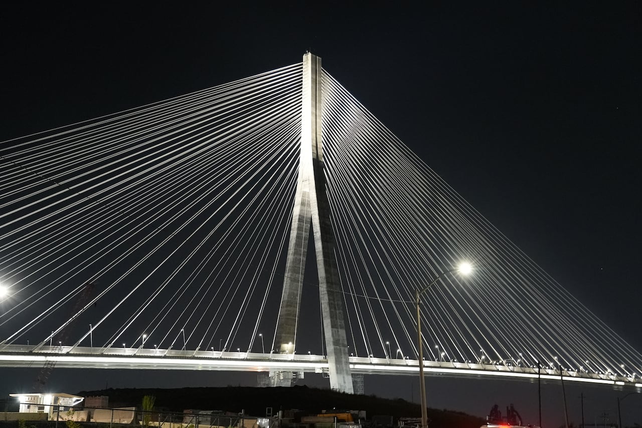 The cables of the Gordie Howe bridge lit up against the night sky