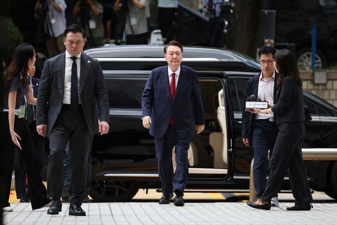 FILE - Former South Korean President Yoon Suk Yeol, center arrives at a court to attend a hearing to review his arrest warrant requested by special prosecutors in Seoul, South Korea, July 9, 2025.