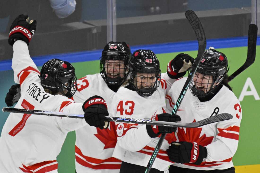 Canada's #43 Kristin O'Neill (2R) celebrates scoring her team's first goal with teammates during the women's gold medal ice hockey match between USA and Canada at the Milano Santagiulia Ice Hockey Arena during the Milan Cortina 2026 Winter Olympic Games.