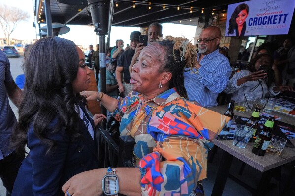 Primary candidate for U.S. Senate Rep. Jasmine Crockett, D-Texas, left, is greeted by Carleetah Saygo, right, after a campaign event in Richardson, Texas, Thursday, Feb. 19, 2026. (AP Photo/LM Otero)