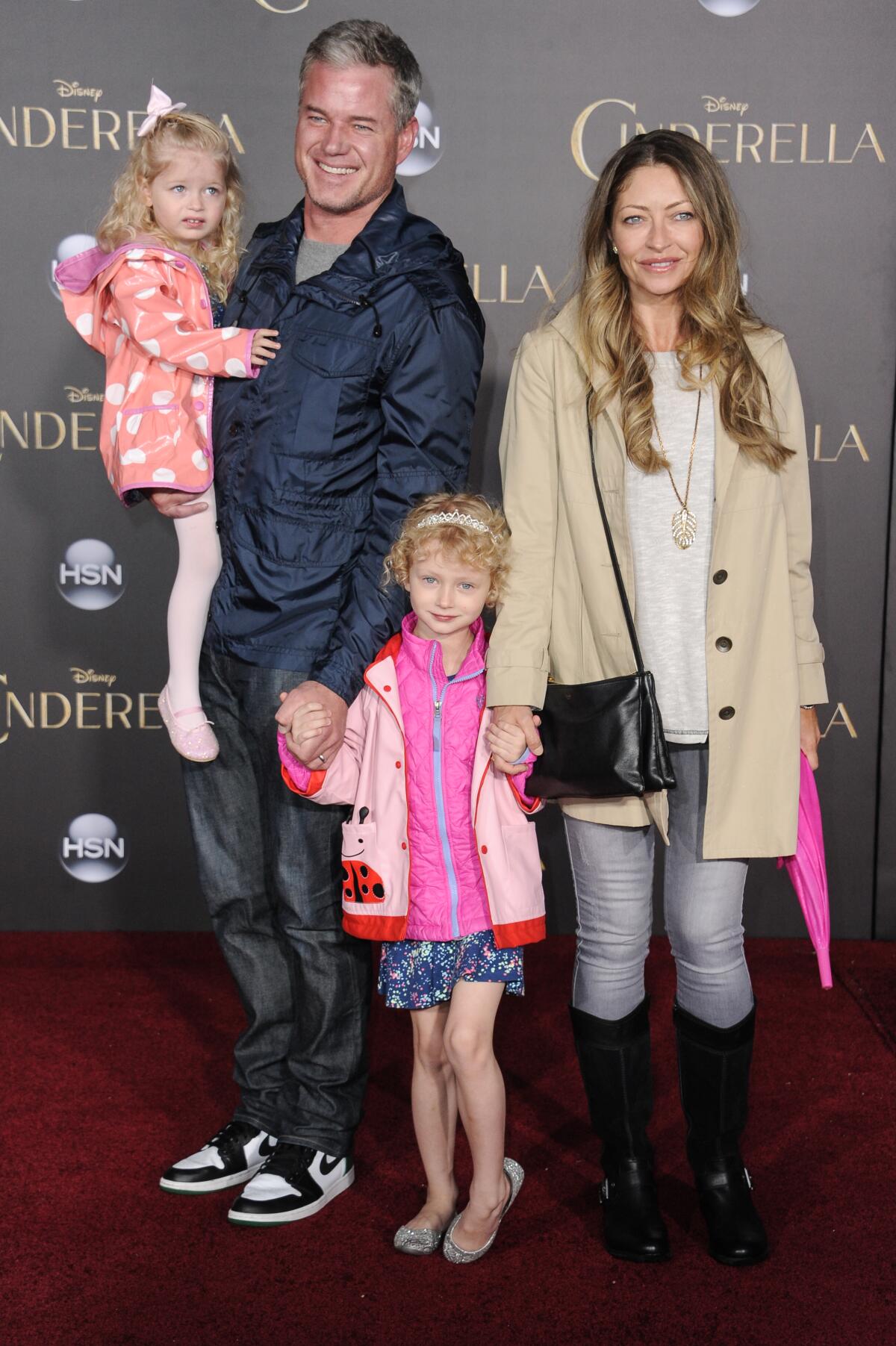Eric Dane carries one young daughter and holds the other daughter's hand along with wife Rebecca Gayheart