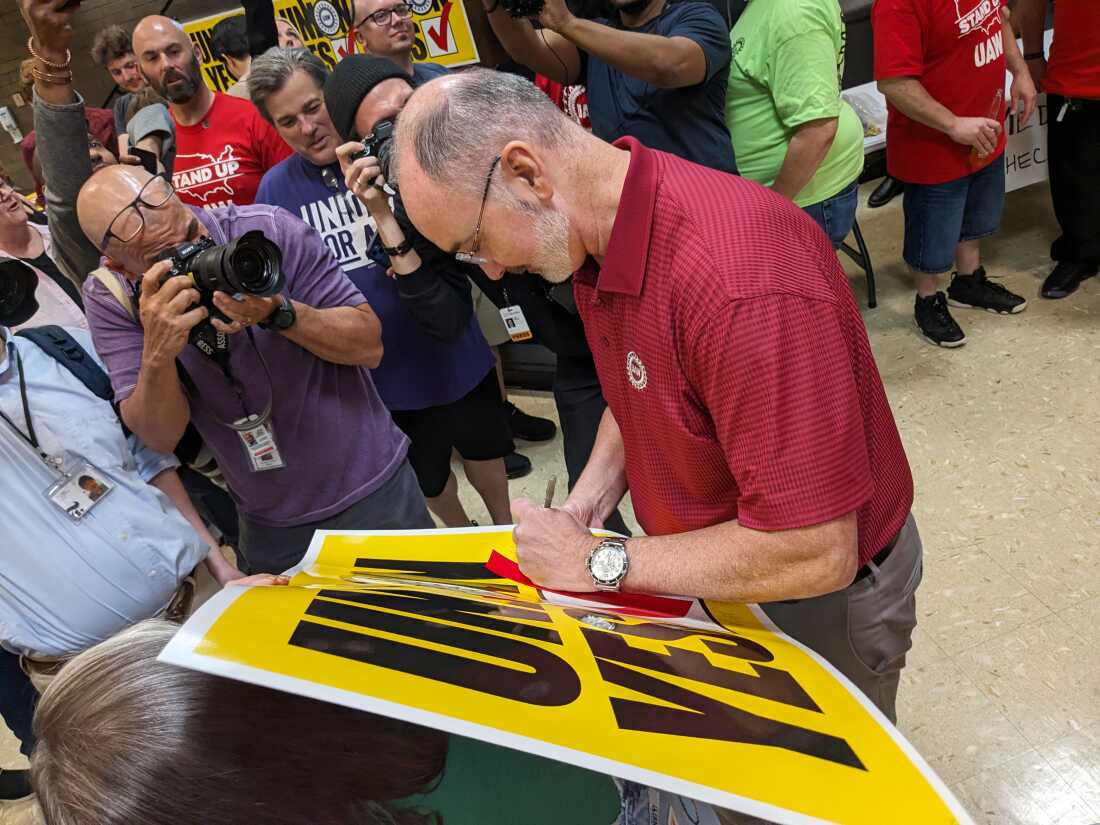 UAW President Shawn Fain signs a "Union Yes" sign at a watch party in Chattanooga, Tenn. after worker voted to join the UAW on April 19, 2024