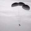 This image, taken from NASA video, shows the Boeing Starliner capsule coming down through the darkness over New Mexico.