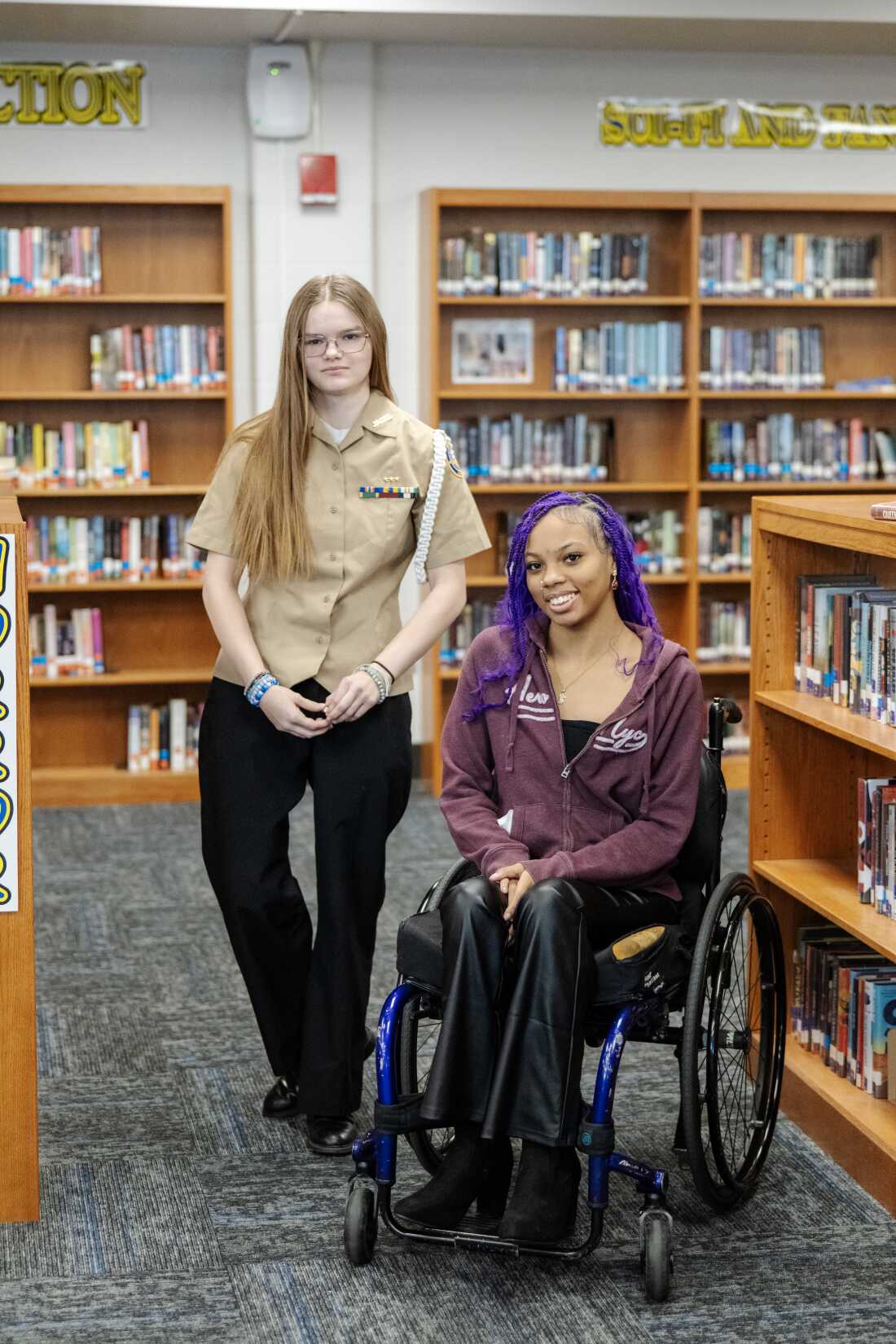 Jayden O’Neil and Quani’e Lanier pose for a photograph in the school library.