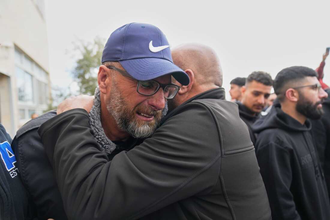 Mourners give condolences to Mohammad Abu Siyam, the father of Palestinian-American Nasrallah Abu Siyam, 19, who according to the Palestinian Health Ministry was shot by settlers on Wednesday night, during his funeral in the West Bank village of Mukhmas, east of Ramallah, Thursday, Feb. 19, 2026. (AP Photo/Nasser Nasser)