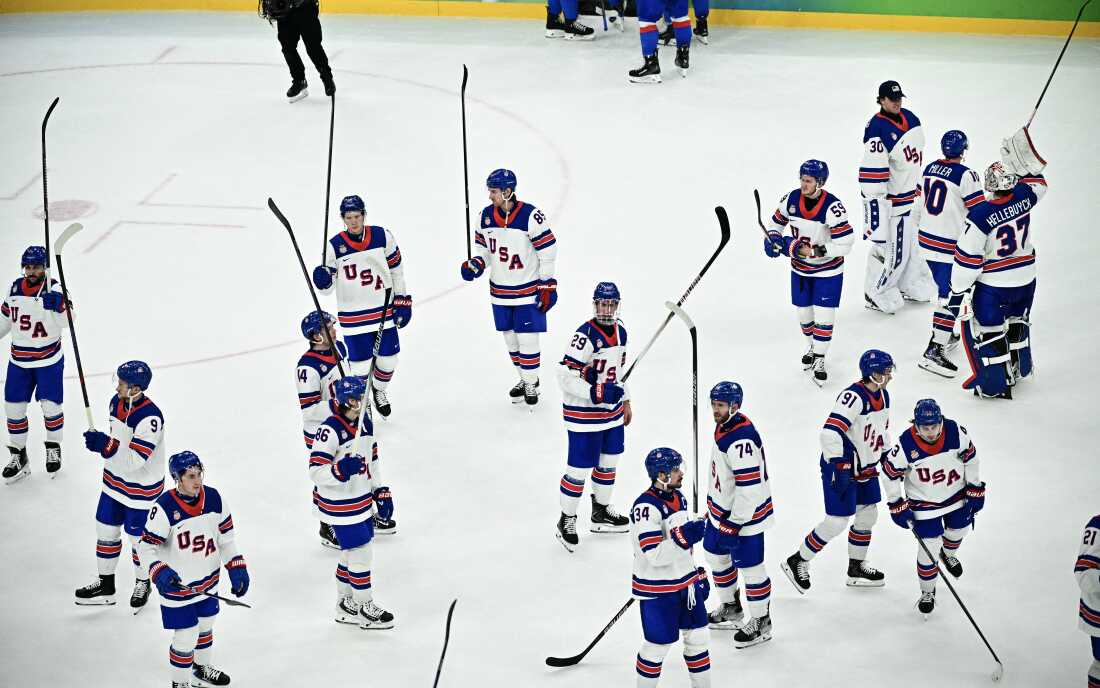 USA's players raise their sticks after winning the men's play-off semi-final ice hockey match between USA and Slovakia at the Milano Santagiulia Ice Hockey Arena during the Milano Cortina 2026 Winter Olympic Games in Milan, on February 20, 2026. USA won 6-2.