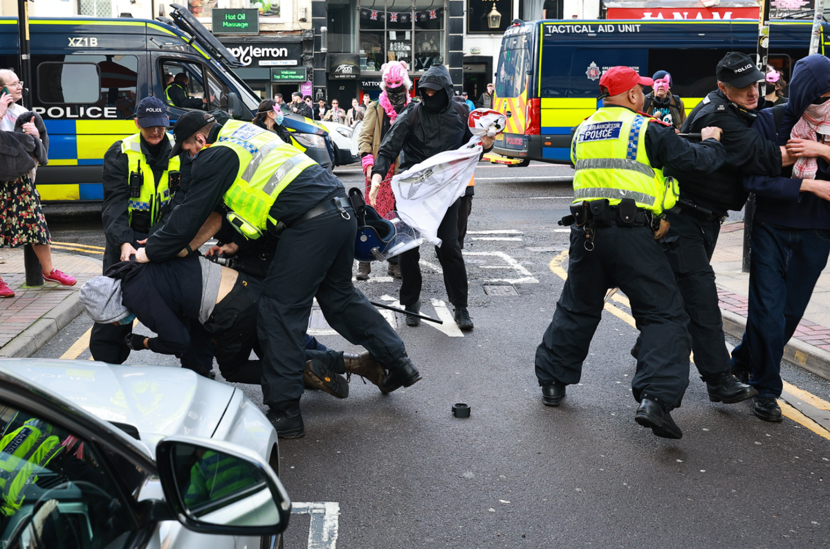 Protesters clash with police in Manchester city centre
