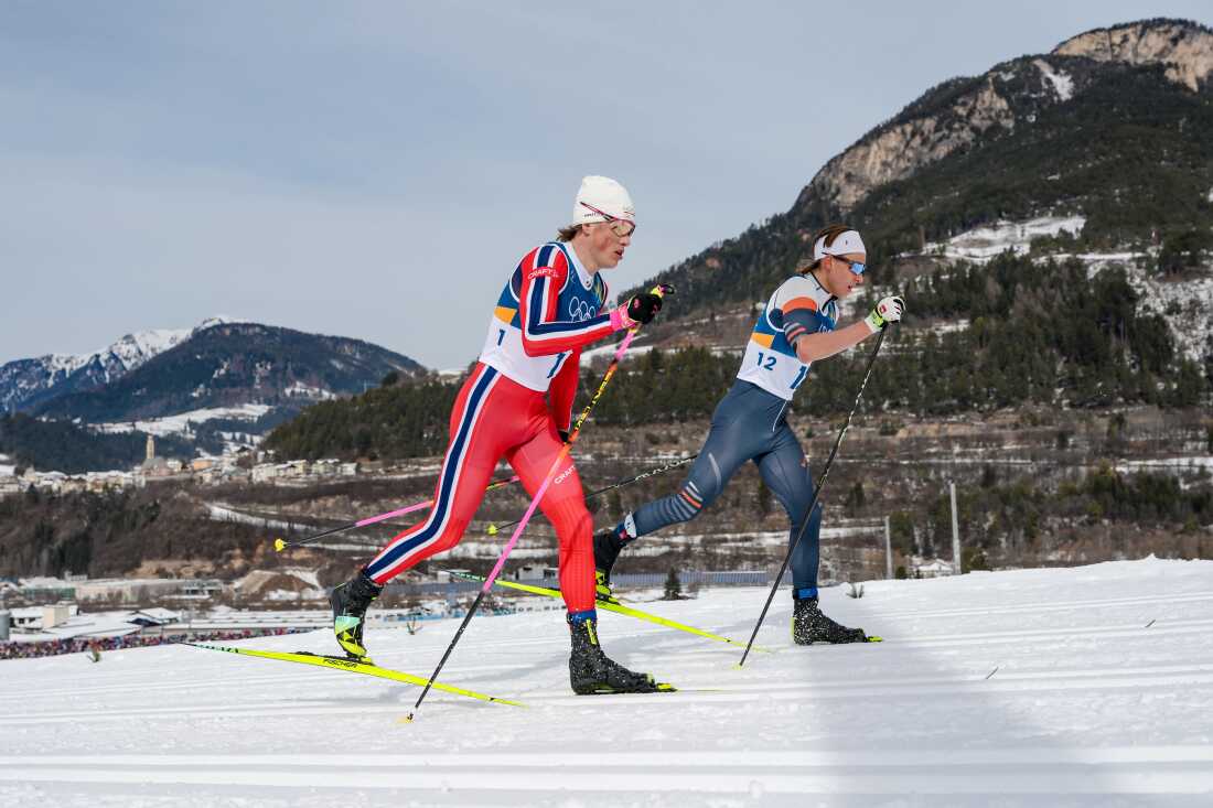 Johannes Hoesflot Klaebo, of Norway, left, and Individual Neutral Athlete Savelii Korostelev compete in the cross country skiing men's 50km mass start Classic at the 2026 Winter Olympics, in Tesero, Italy, Saturday, Feb. 21, 2026.