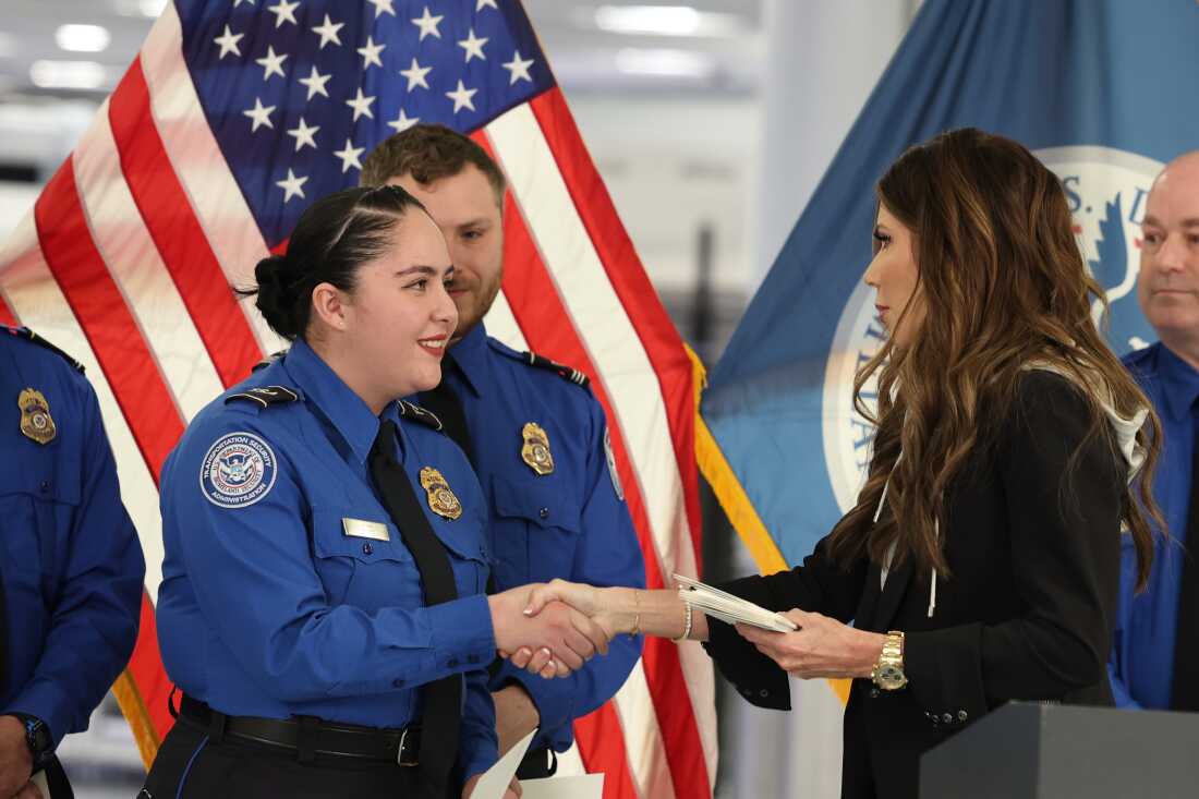 FILE - U.S. Homeland Security Secretary Kristi Noem, right, shakes hands with Transportation Security Administration Officer Monica Degro at a news conference at Harry Reid International Airport, Nov. 22, 2025, in Las Vegas.