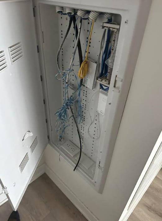 A damaged utility box within Tim Rye's Toronto condo. He says modems were removed from within the metal cabinet by the tenant and are missing.