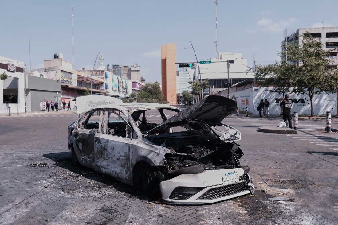 A vehicle sits charred after being set on fire, on a road in Guadalajara, Jalisco state, Mexico, Sunday, Feb. 22, 2026, after the death of the leader of the Jalisco New Generation Cartel, Nemesio Rubén Oseguera Cervantes, known as"El Mencho."