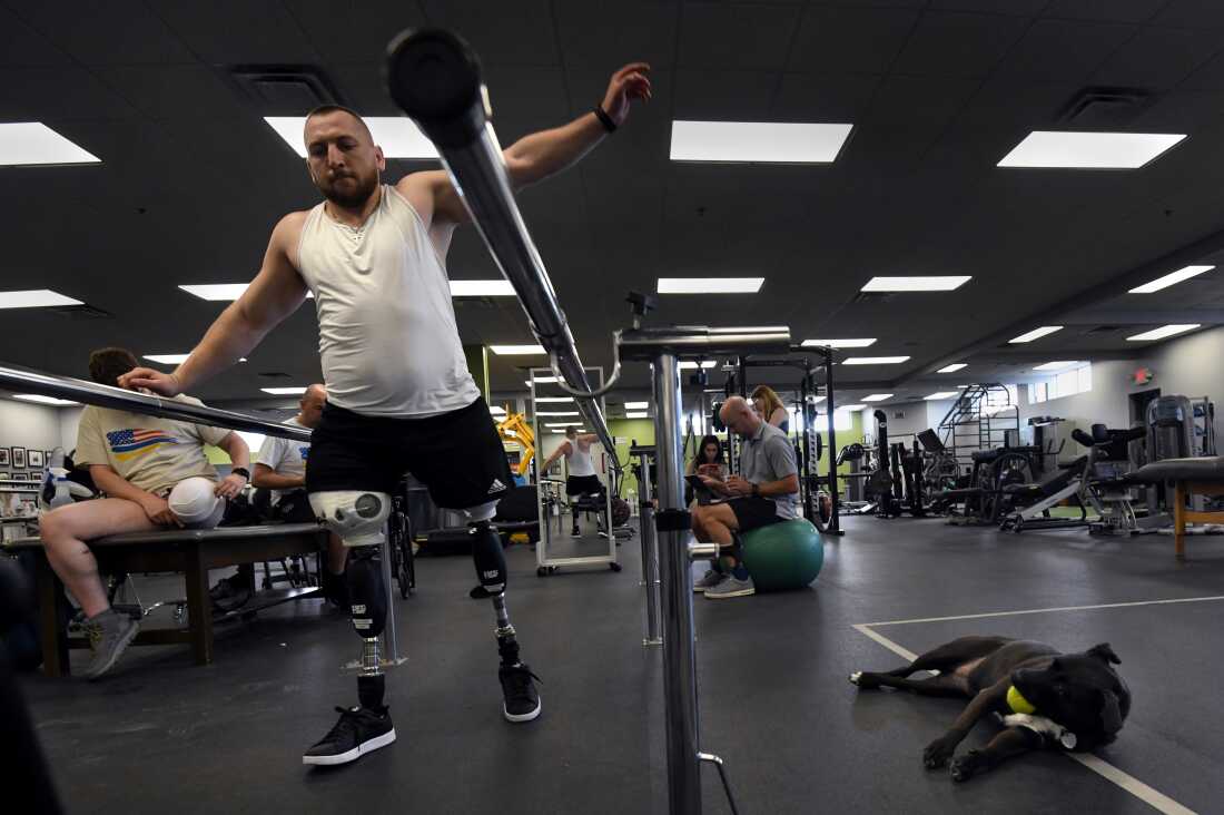 Sgt. Misha Varvarych, a Ukrainian war amputee, tries to keep balance as he begins walking on his new prosthetic legs at the Prosthetic & Orthotic Associates center in Orlando, Fla., on Jan. 31, 2023.