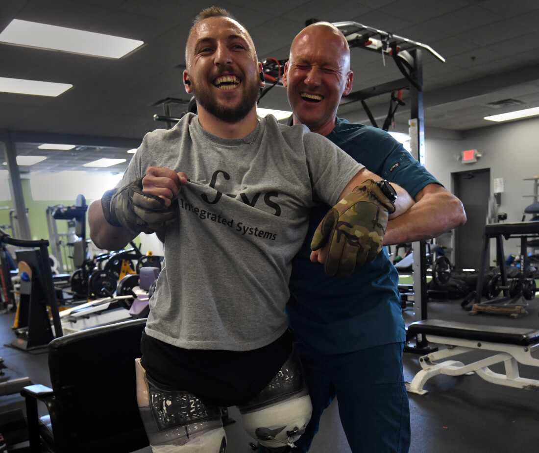 Sgt. Misha Varvarych, 28, a Ukrainian war amputee gets assistance after a fall from Certified Prosthetist Joseph Krizinauskas while learning to walk on his new legs