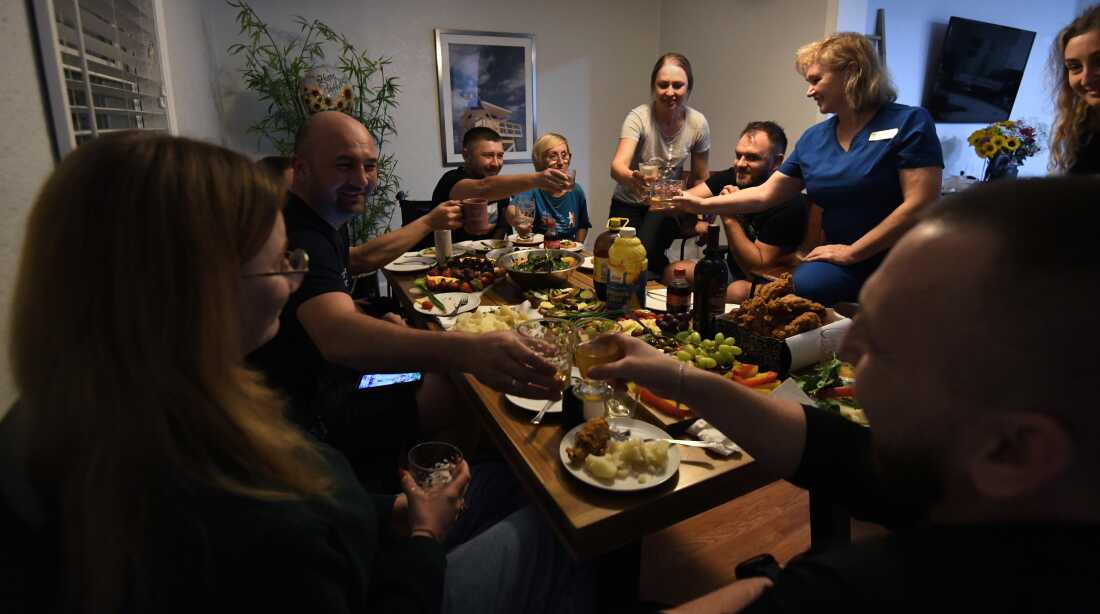 Misha Varvarych and his fiancé Ira Botvynska have dinner at a group home they share with other Ukrainian amputee soldiers and the volunteers assisting them for Revived Soldiers Ukraine in Orlando Florida
