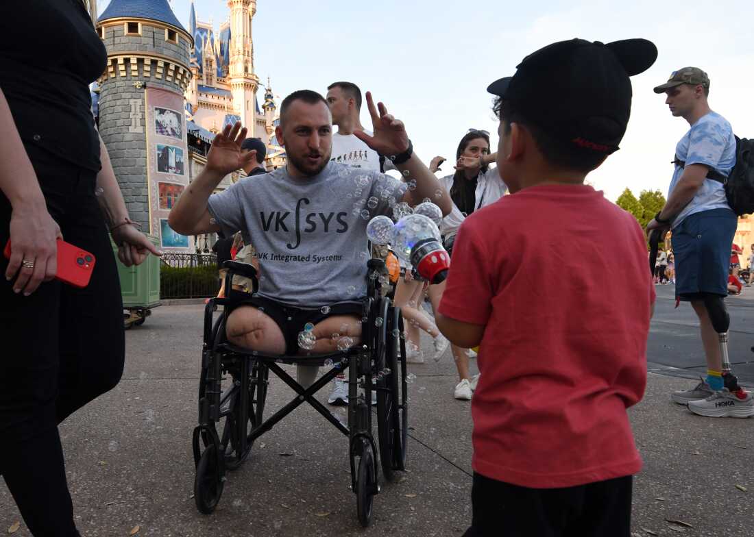 Sgt. Misha Varvarych, a Ukrainian war amputee, visits DisneyWorld in Orlando Florida with his fiance Ira Botvynska and other soldiers