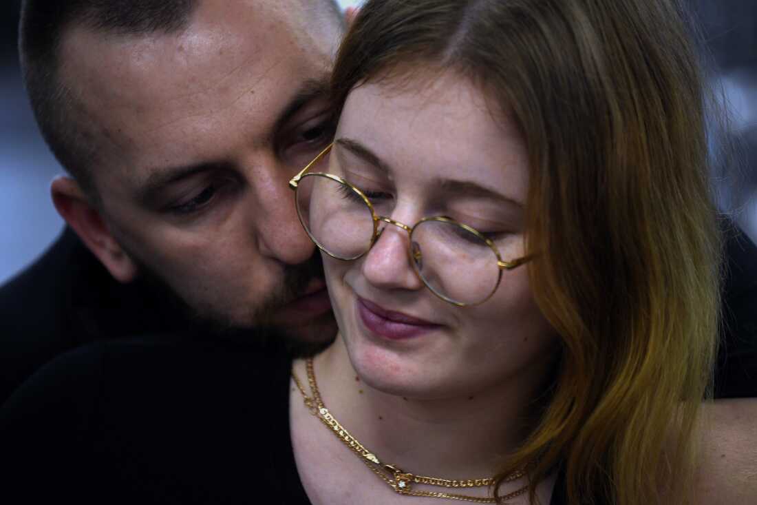 Sgt. Misha Varvarych, a Ukrainian war amputee, cuddles with Ira Botvynska