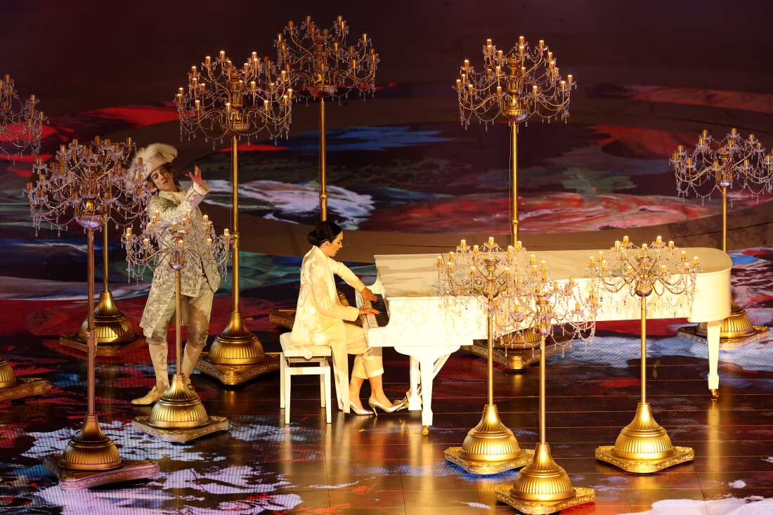 Gloria Campaner plays the piano, surrounded by candelabras, at Sunday's closing ceremony.