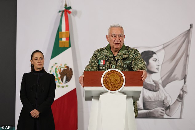 Mexican Defense Minister Gen. Ricardo Trevilla Trejo speaks as President Claudia Sheinbaum looks on during her daily, morning news conference at the National Palace in Mexico City, Monday, Feb. 23, 2026, the day after the Mexican army killed Jalisco New Generation Cartel leader Nemesio Oseguera, known as "El Mencho." (AP Photo/Ginnette Riquelme)