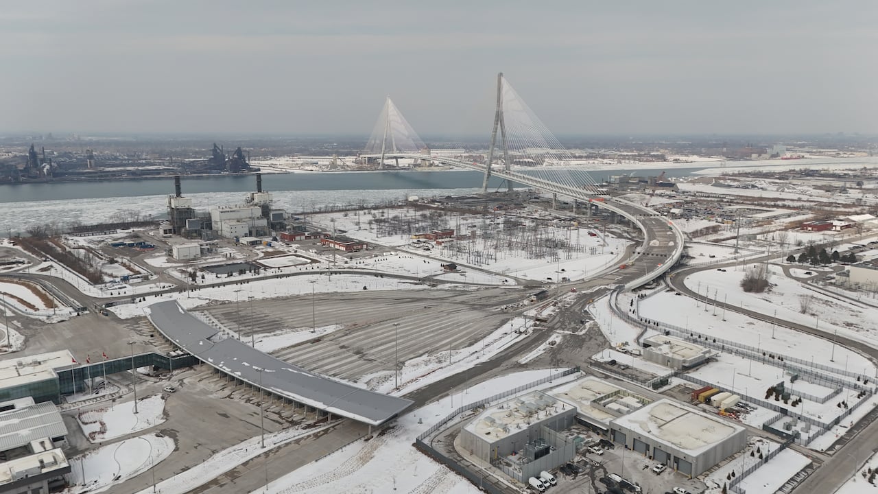 A snowy bridge over a river