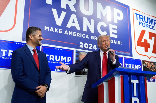 Republican presidential nominee former President Donald Trump speaks as Hamtramck Mayor Amer Ghalib listens at a campaign office, Oct. 18, 2024, in Hamtramck, Mich. (AP Photo/Evan Vucci, File)