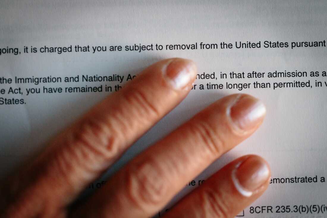 An adoptee brought to the United States by her American parents from Iran as a young child holds the immigration removal order she received recently, photographed in Southern California on Feb. 21.