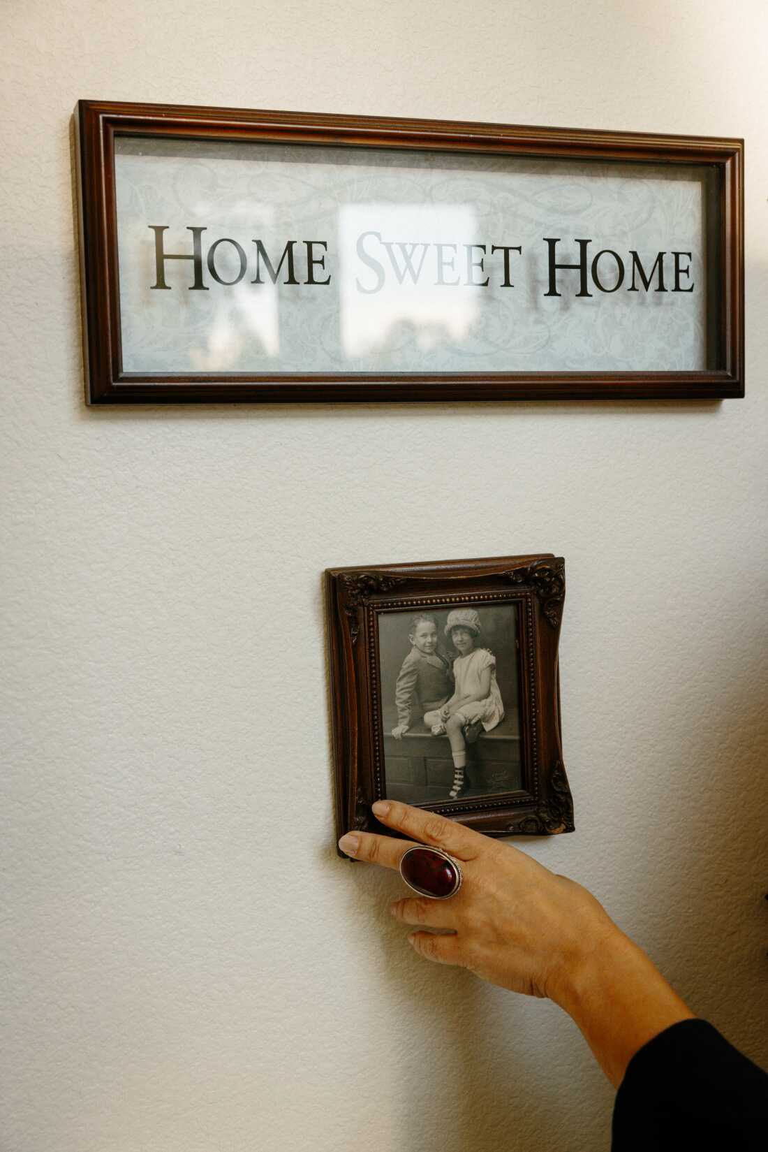 A “Home Sweet Home” decoration along with family portraits of an adoptee’s American family in her home in Southern California on Feb. 21.