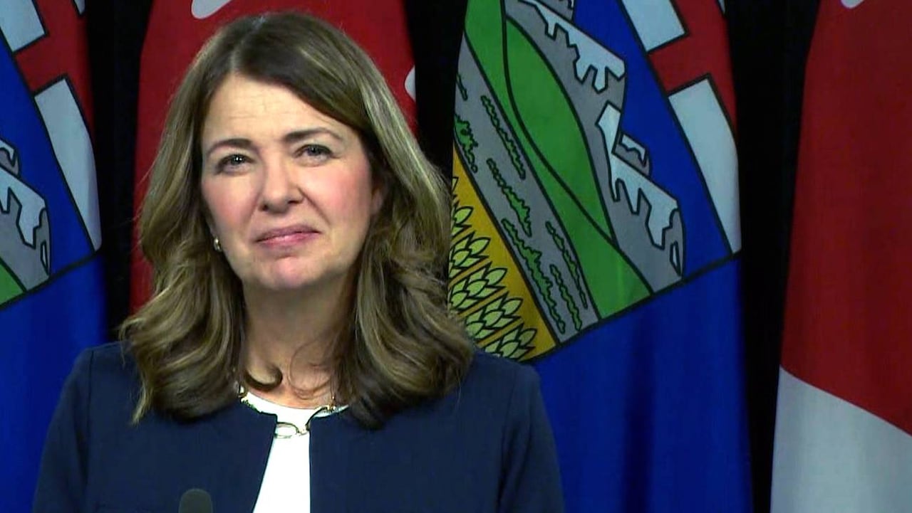 A woman stands at a podium.