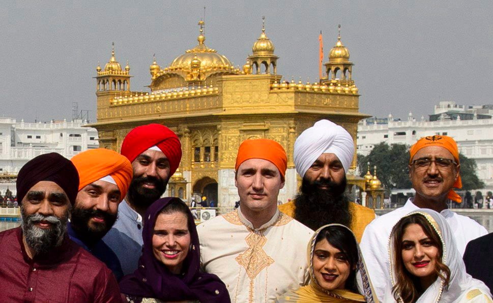 Prime Minister Justin Trudeau, centre, stands beside Surrey Centre MP Randeep Sarai, top centre right, as they join fellow MPs for a group photo while visiting the Golden Temple in Amritsar, India on Wednesday, Feb. 21, 2018.