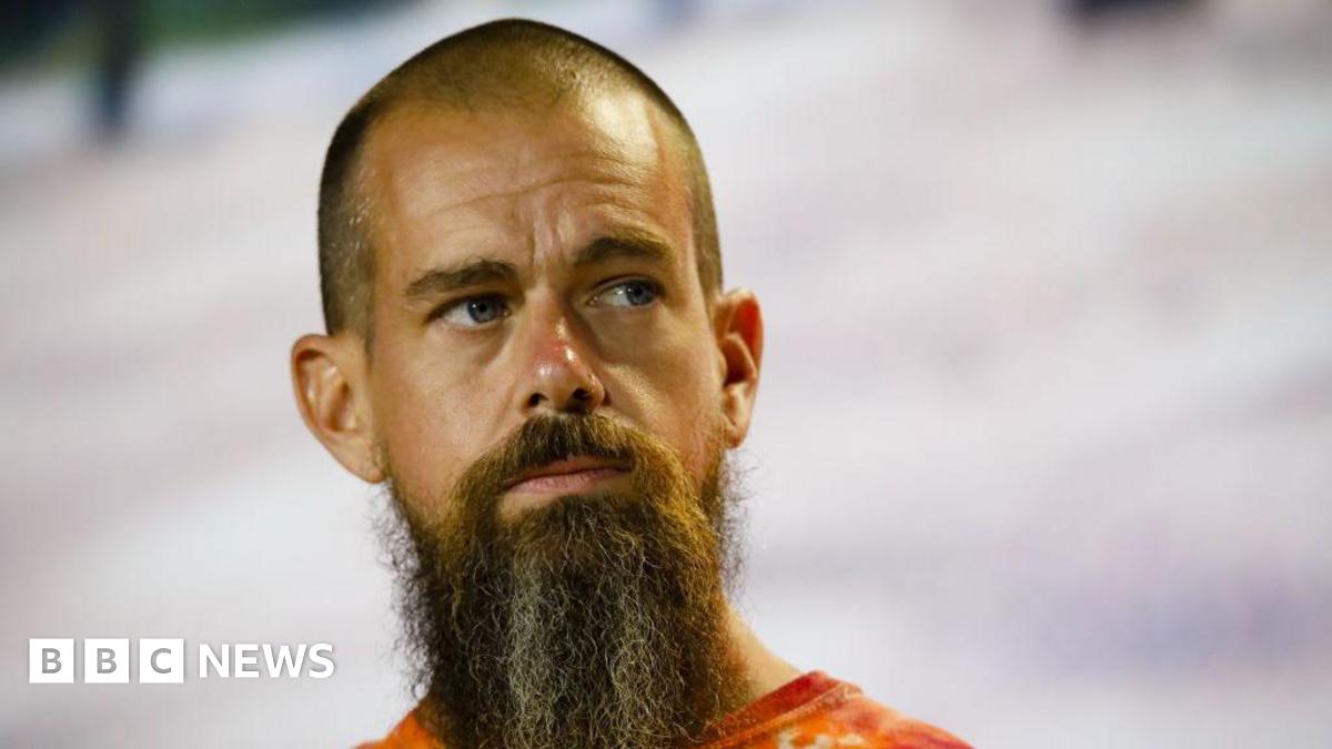 Close up of Jack Dorsey looking thoughtfully upwards. He has a close shaved head and a bushy long beard. There is snow in the background