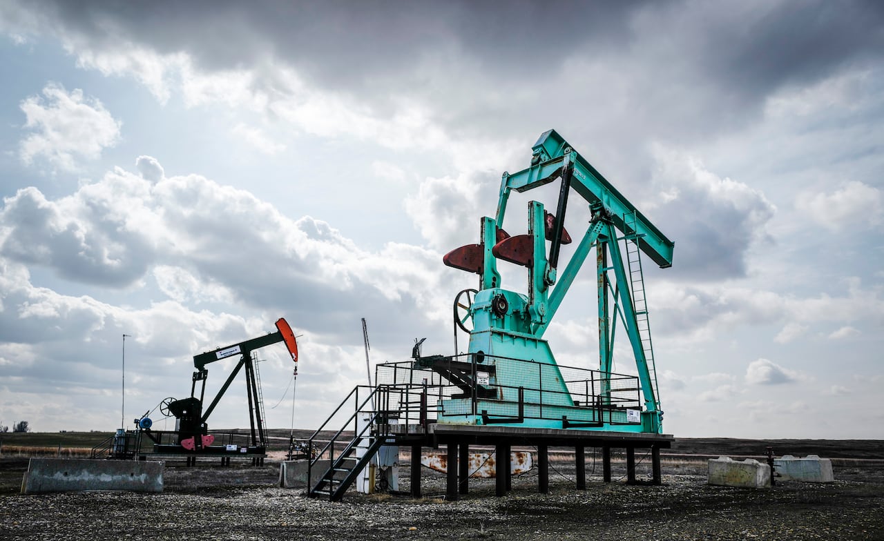 A de-commissioned pumpjack, right, sits idle beside a functioning one drawing out oil and gas from a well head near Carstairs, Alta., Tuesday, April 1, 2025. Canada has the third largest oil reserves in the world and is the world's fourth largest oil