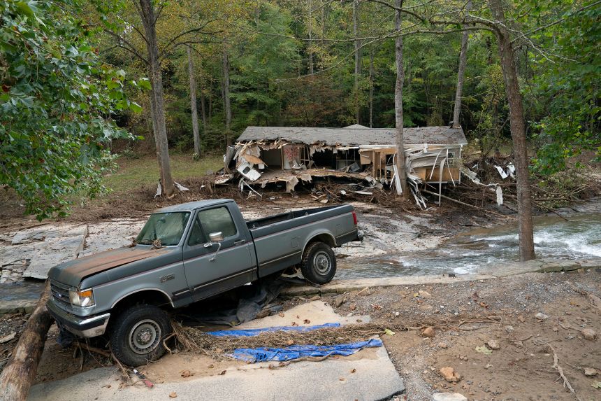 A damaged truck and home are seen in Black Mountain, North Carolina, on October 3, 2024, after the passage of Hurricane Helene.