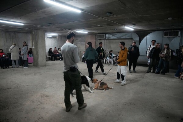 People in a shelter following alarms for incoming missile from Iran after The United States and Israel launched an attack on Iran, in Tel Aviv, Israel, Saturday, Feb. 28, 2026. (AP Photo/Ohad Zwigenberg)