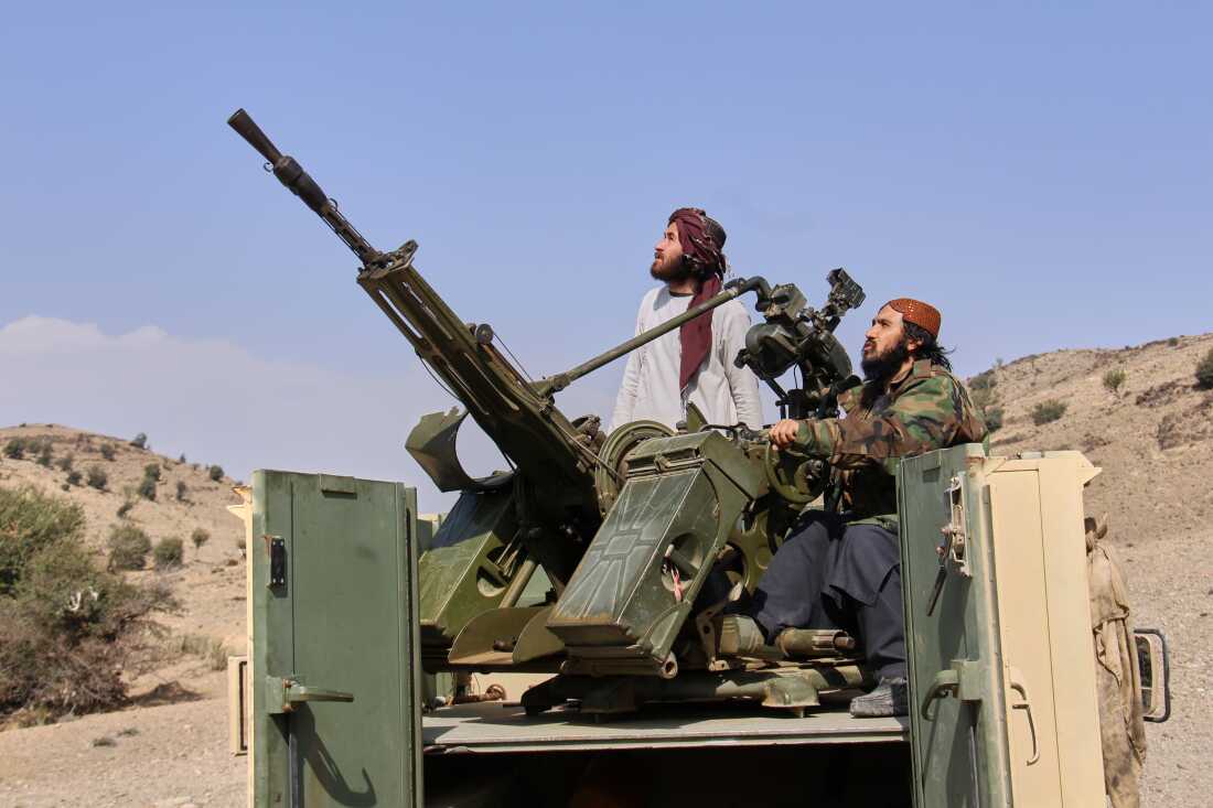 Taliban fighters look up while manning an armed pickup truck at the Afghan side of the Ghulam Khan crossing with Pakistan in Khost province, Afghanistan, Friday.