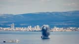 TOPSHOT - An incoming projectile explodes over the water in the bay of Haifa off of the northern Israeli coastal city on February 28, 2026. The United States and Israel launched strikes against Iran on February 28, with Israel's public broadcaster reporting that supreme leader Ayatollah Ali Khamenei had been targeted, as the Islamic republic retaliated with barrages of missiles at Gulf states and Israel. (Photo by Jalaa MAREY / AFP via Getty Images)