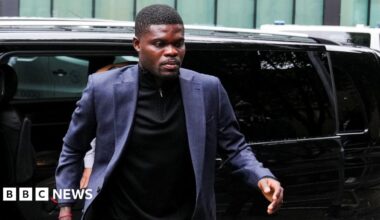 Thomas Partey walks towards the camera as he exits a car