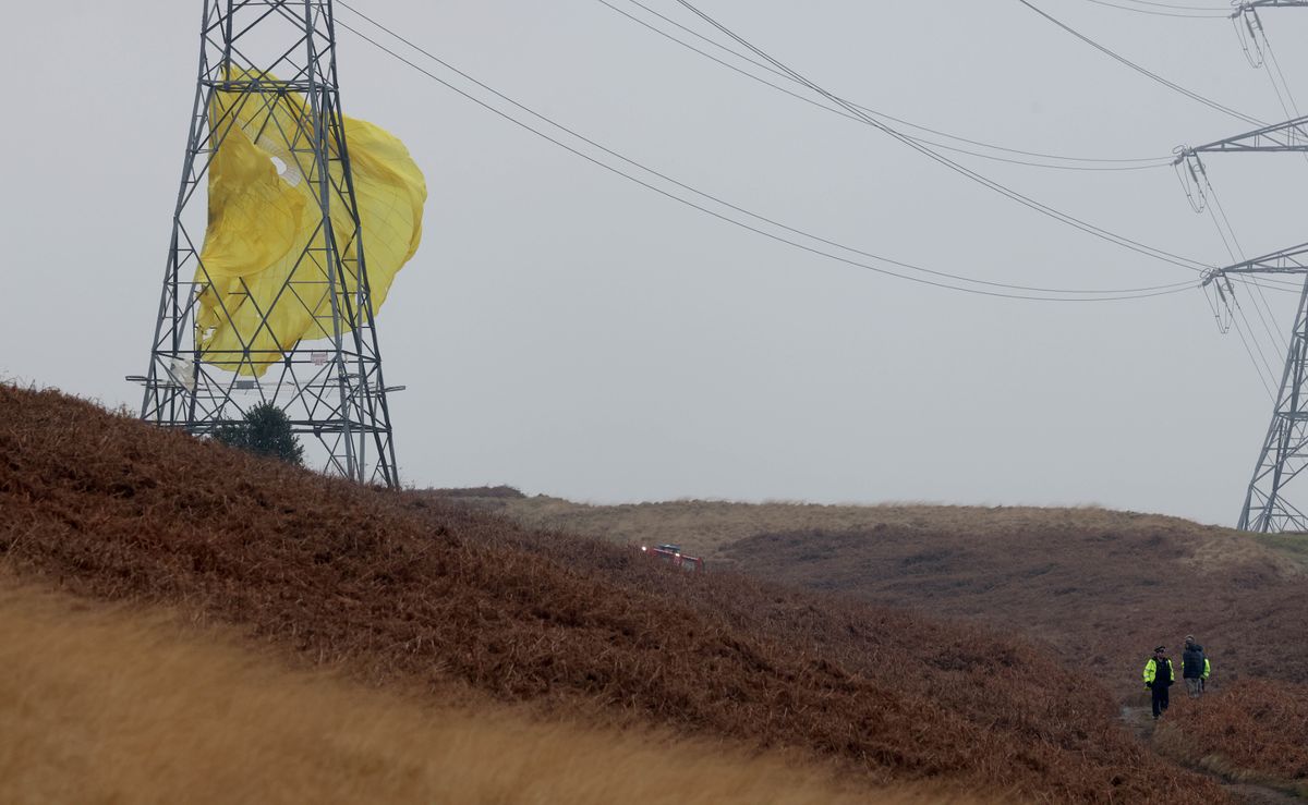 A parachute got caught on a nearby pylon beside the crash site
