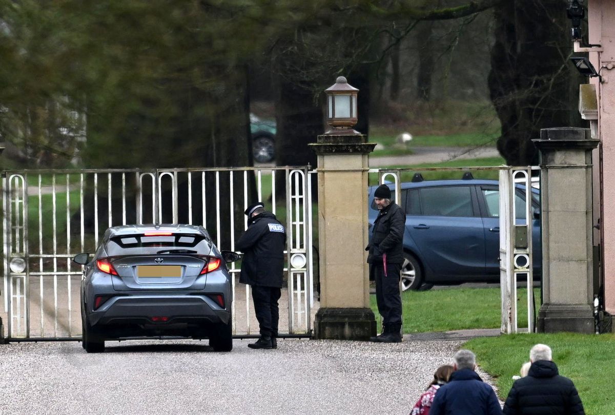 Police officers at the gates of Andrew's former home in Windsor