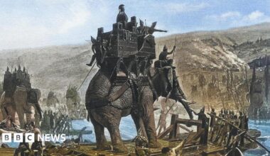 An illustration of an elephant with soldiers crossing a river