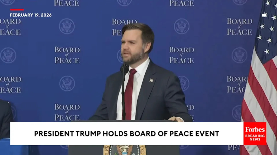A man stands at a podium with a "Board of Peace" backdrop at an event labeled as "President Trump Holds Board of Peace Event," dated February 19, 2026
