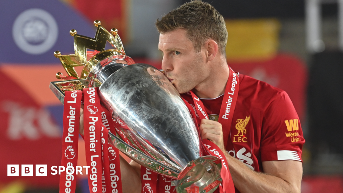 Liverpool's James Milner kisses the Premier League trophy in 2020
