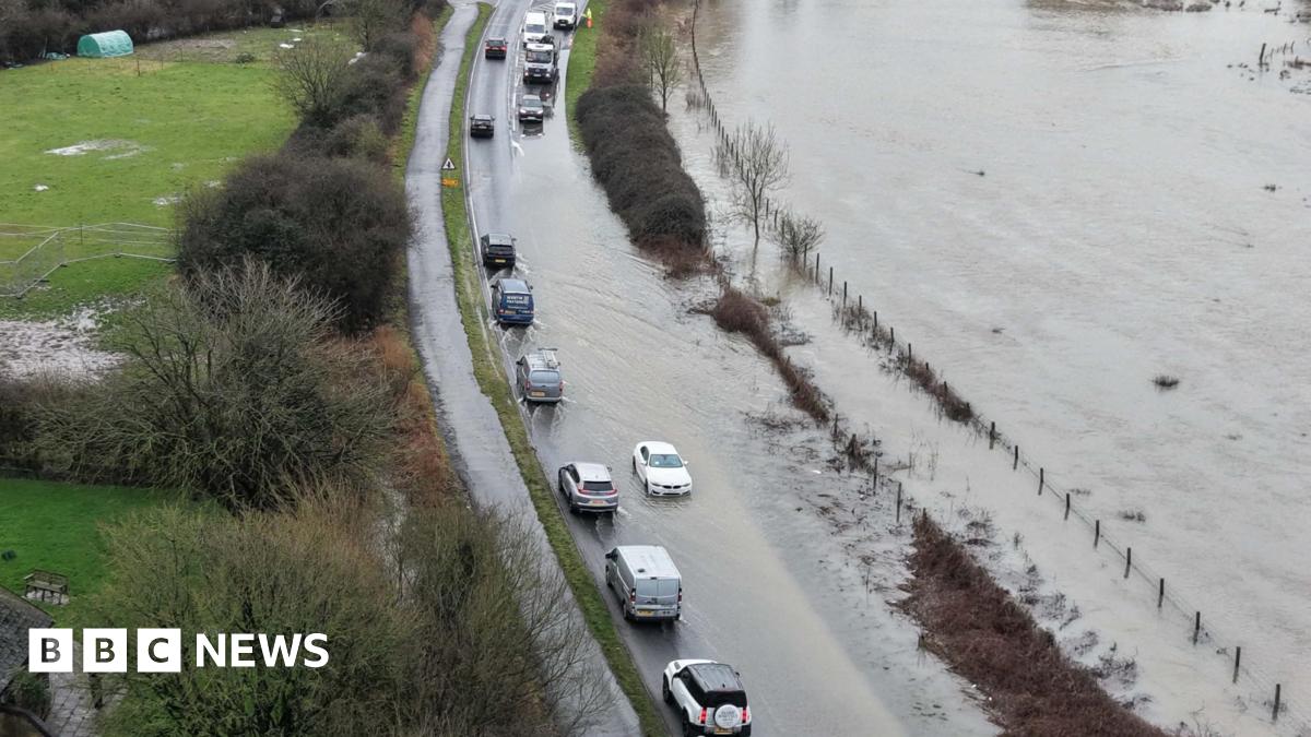 Vehicles on a road that is flood due to storm Chandra and the heavy rain last week.